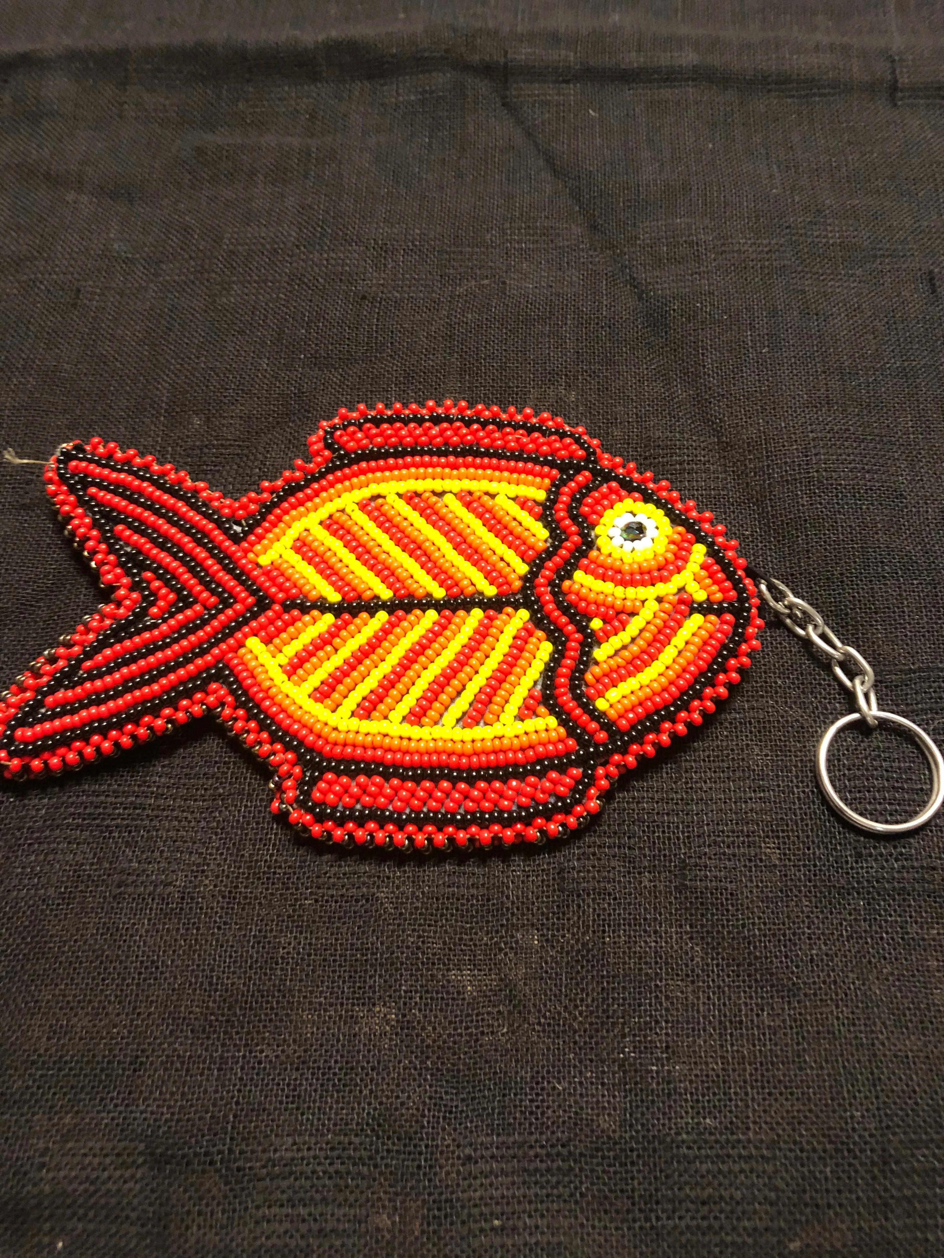 Guatemalan handcrafted glass bead round change purse with key ring. 3.5” diameter.  Fish design.