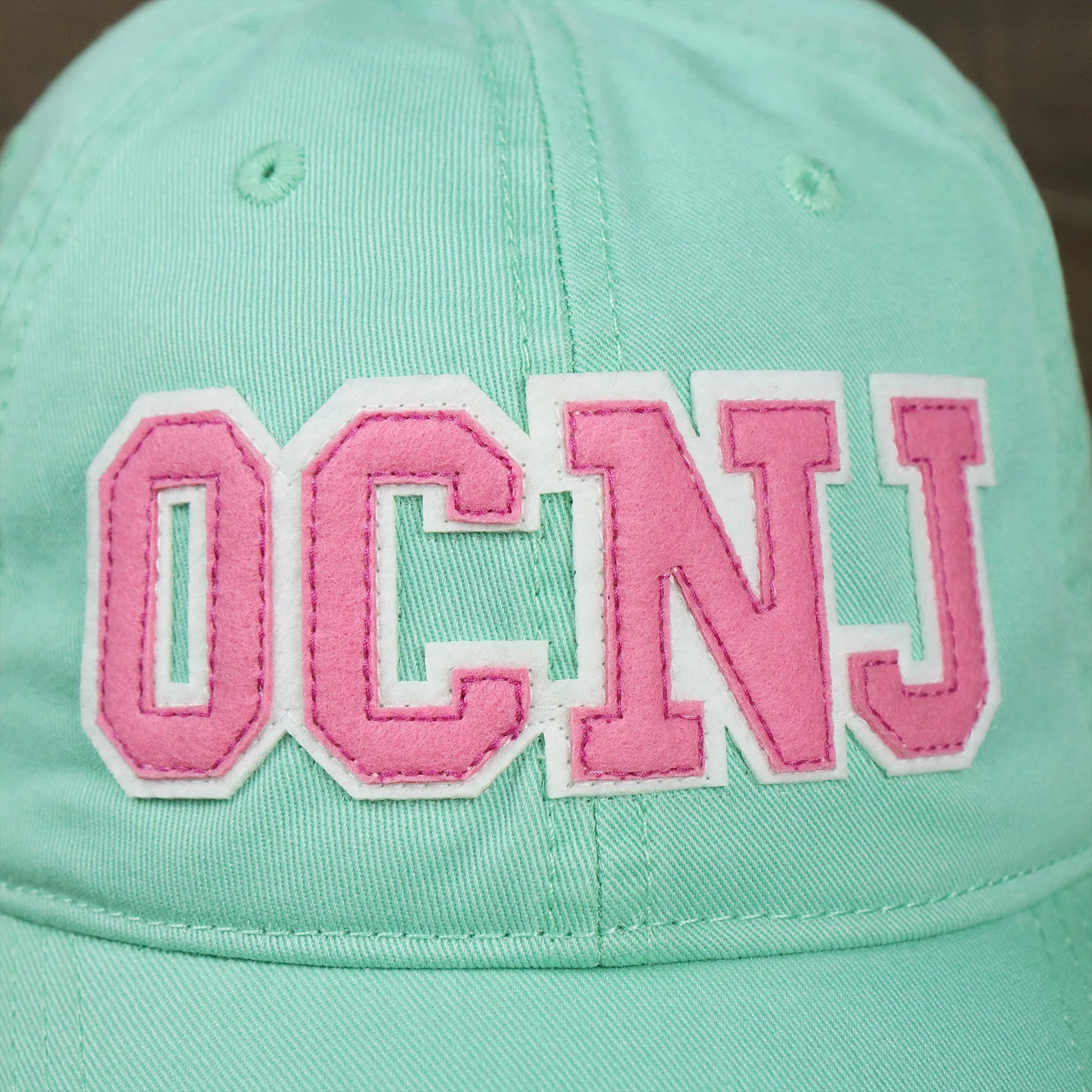 Youth Pink OCNJ Wordmark White Outline Dad Hat | Spearmint Youth Dad Hat